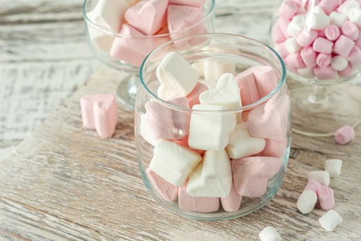 Assorted pink and white marshmallows in glass cups on wooden background. Heart shape marshmallow for hot chocolate or cacao photo
