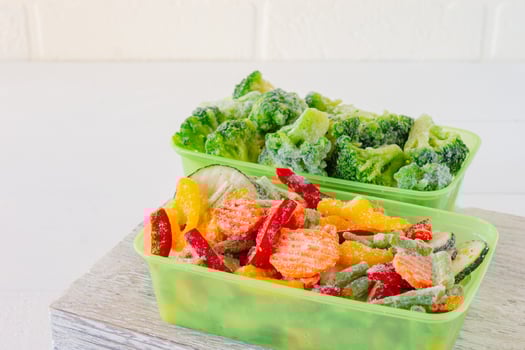 Mix of frozen vegetables in plastic storage containers. Stocks of meal for the winter. photo