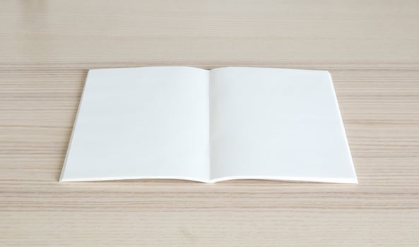 Mock up blank open paper book on wood table background photo