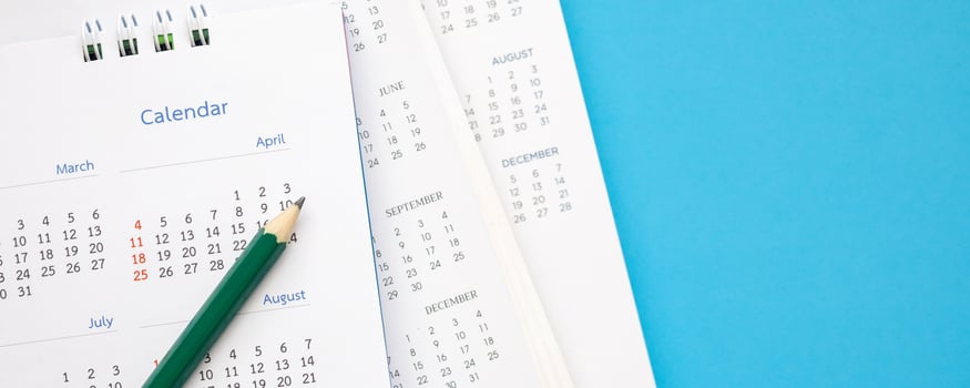 calendar page with pencil close up on blue background business planning appointment meeting concept photo