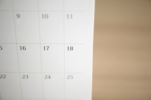calendar page close up on wood table background business planning appointment meeting concept photo