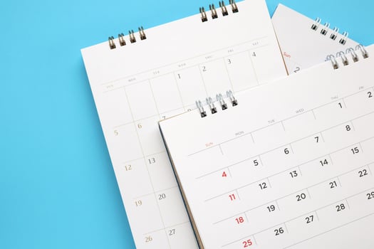 calendar page close up on blue background business planning appointment meeting concept photo