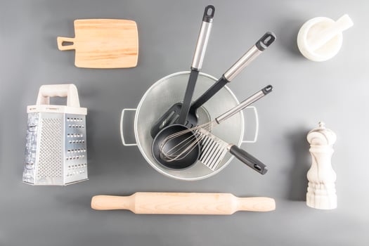 various kitchen utensils made of wood, metal, ceramics on a gray background. top view. flat lay. photo