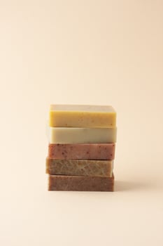 Soap on pastel beige background. Close up, copy space photo