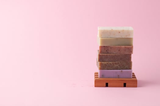 Soap on pink background. Close up, copy space photo