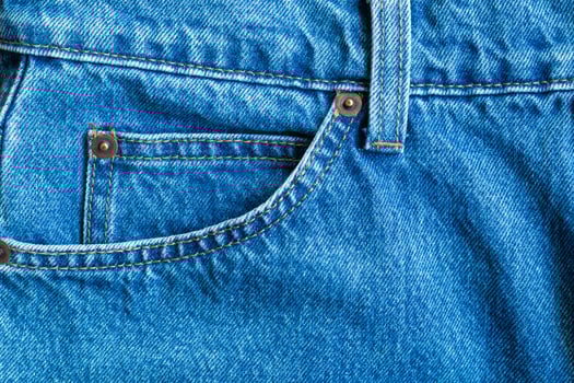 Blue denim Jeans pocket texture background closeup photo