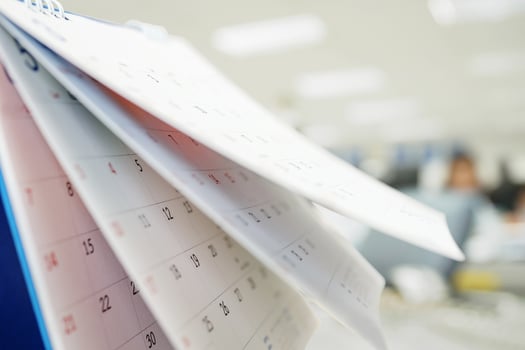 Calendar page flipping sheet close up on office table interior background business schedule planning appointment meeting concept photo