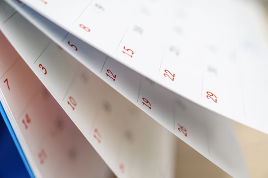 Calendar page flipping sheet close up on office table background business schedule planning appointment meeting concept photo