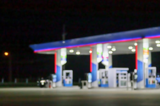 Petrol gas station at night time blurred background with bokeh light photo