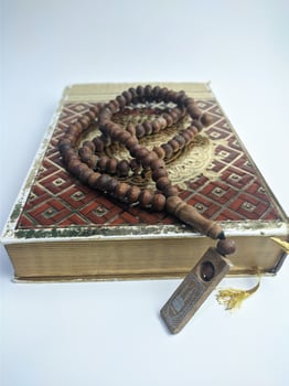 Islamic concept - The Holy Al Quran, on white background, with copy space photo