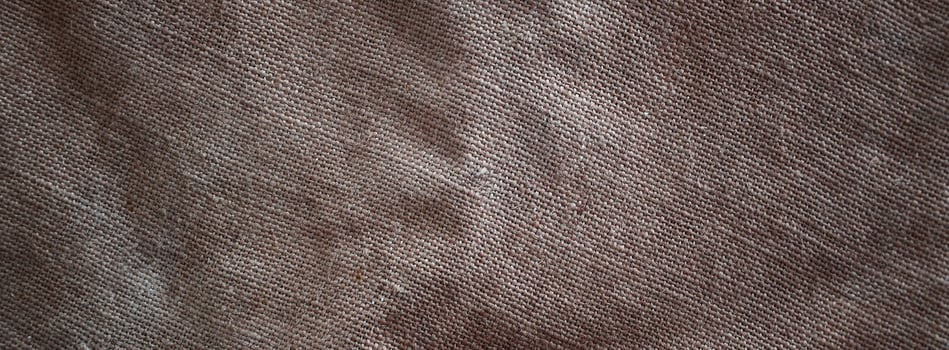 The texture of a very old brown sack cloth. Retro texture with canvas material. Background image with copy space photo