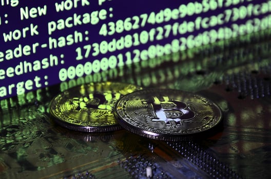 The digital process of cryptocurrency mining by using the GPUs. Bitcoins and video card on a working display and mining screen photo