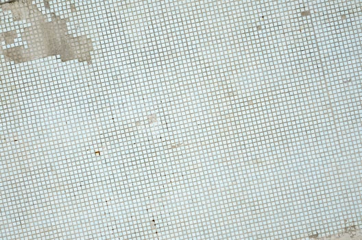 The texture of the old wall, decorated with a lot of square small tiles. Wall in the style of architecture of the Soviet Union photo