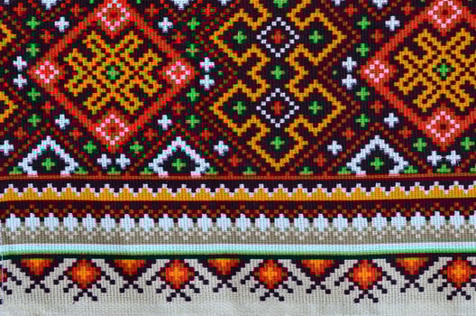 Traditional Ukrainian folk art knitted embroidery pattern on textile fabric photo