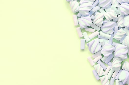 Colorful marshmallow laid out on lime paper background. pastel creative texture photo