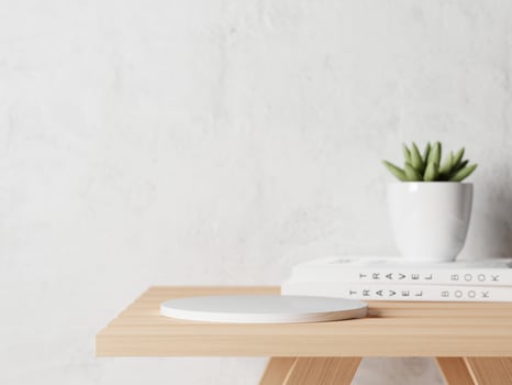 3d ceramic display podium with succulent in vase and white books on the wooden table. 3d rendering of realistic presentation for product advertising. 3d illustration. photo