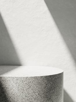 3d granite display podium with sunlight against white concrete wall. 3d rendering of realistic presentation for product advertising. interior illustration. photo