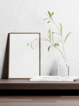 3d empty picture frame on the wooden shelf with books and plant in vase. 3d rendering of picture frame mock up. 3d illustration. photo