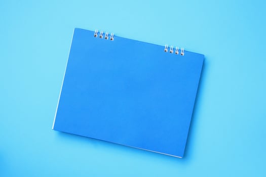Empty blank calendar on blue background photo