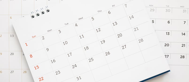 calendar page close up on blue background business planning appointment meeting concept photo