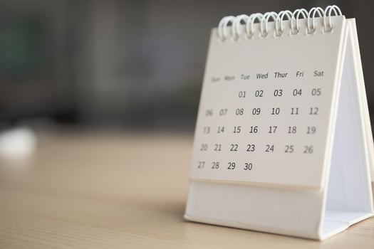 Calendar page close up on wood table background business planning appointment meeting concept photo