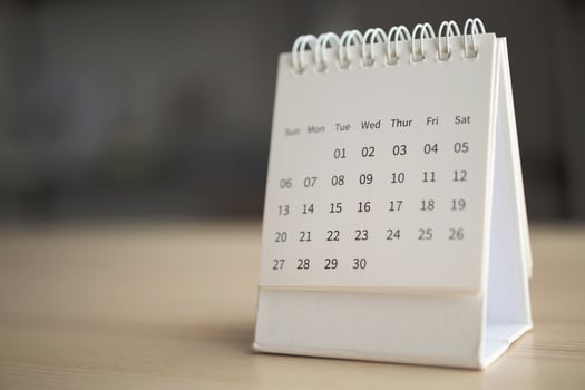 Calendar page close up on wood table background business planning appointment meeting concept photo