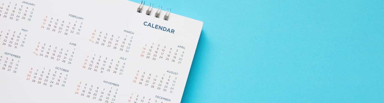 calendar page close up on blue background business planning appointment meeting concept photo
