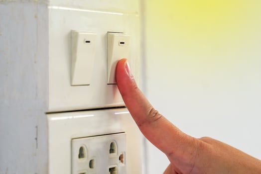 Turn off the lights before leaving the office. Concept to conserve energy and the environment, reduce global warming, save energy. Soft and selective focus. photo