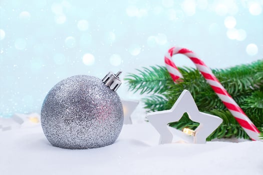 Silver ball, stars lanterns, fir branches and candy cane on snow. Soft focus. Concept of Christmas, New Year. Copy space photo