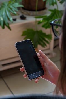young hispanic woman, looking at her cell phone checking her social networks photo