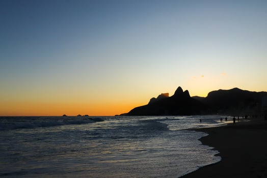 Rio de Janeiro, RJ, Brazil, 2022 - Ipanema at sunset, people walking on the beach in silhouette photo