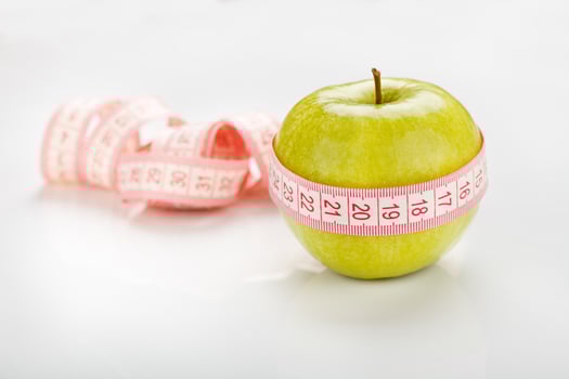 green apple with measuring tape photo