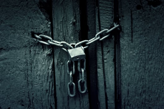 Old padlock on a fence photo