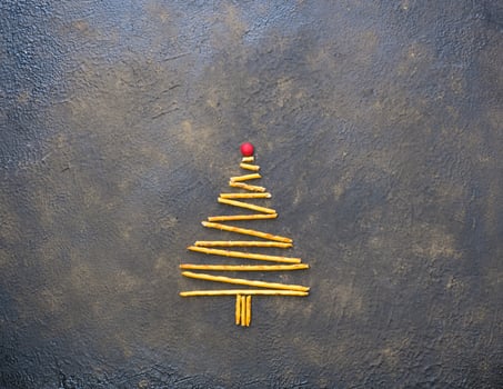 Christmas tree made of cookies, on a black texture background. photo