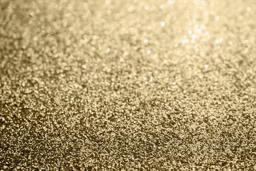Abstract gold glitter sparkle blurred with bokeh background photo