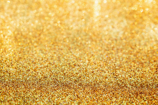 Abstract gold glitter sparkle blurred with bokeh background photo