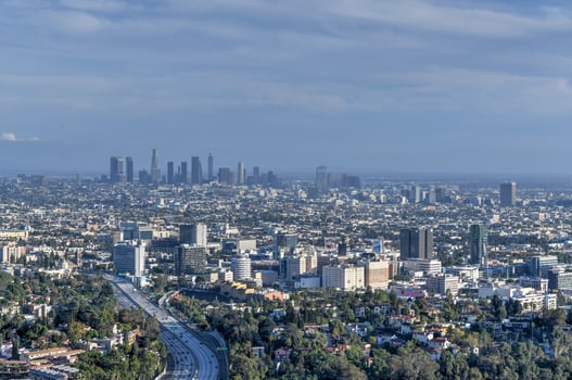 Downtown Los Angeles skyline over blue cloudy sky in California from Hollywood Hills. photo