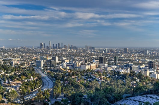 Downtown Los Angeles skyline over blue cloudy sky in California from Hollywood Hills. photo