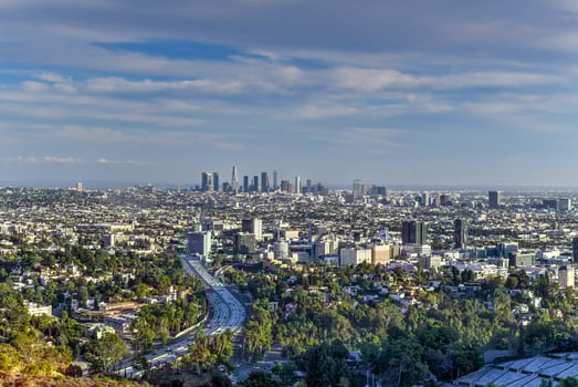 Downtown Los Angeles skyline over blue cloudy sky in California from Hollywood Hills. photo