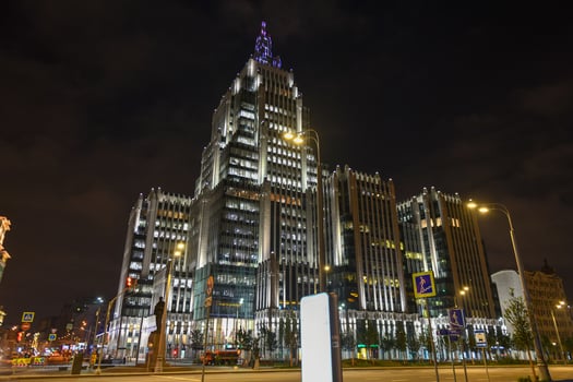 Multifunctional business center Oruzheynyy, a high-rise building in Moscow, Russia at night. photo
