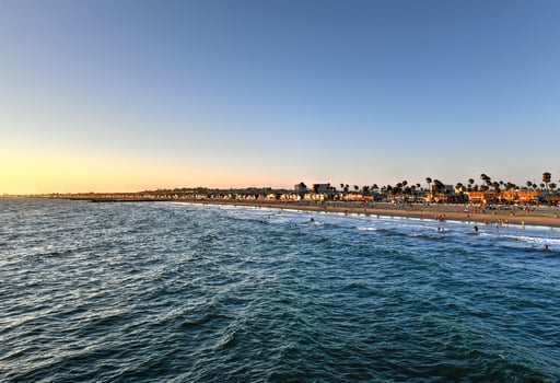 Waves in the Pacific Ocean and view of the beach at sunset, in Newport Beach, California. photo
