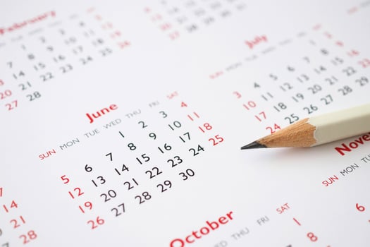 white pencil on calendar background business planning appointment meeting concept photo