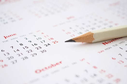 white pencil on calendar background business planning appointment meeting concept photo
