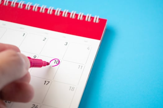 important appointment schedule write on white calendar page date on blue background photo