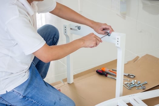 Assembly furniture using screwdriver at home photo