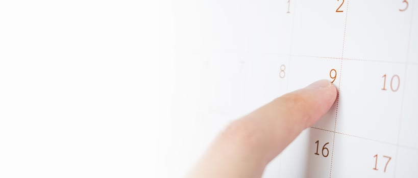 Finger pointing on calendar date background photo