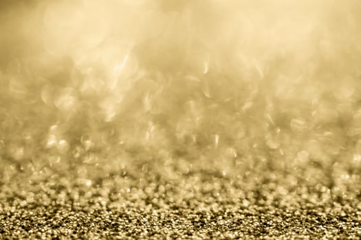 Abstract gold glitter sparkle blurred with bokeh background photo