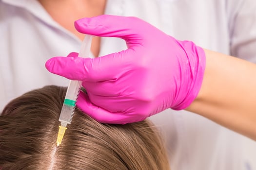Woman receives injection in head photo