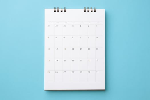 desk calendar on blue background business planning appointment meeting concept photo