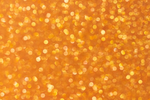 Yellow, orange, golden abstract blured background with shimmer, glitter and shine. Summer, spring, Merry Christmas or new year bokeh. Copy space photo